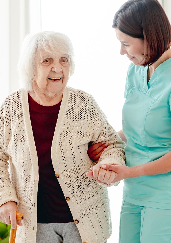 caregiver-helping-elderly-woman-to-walk-2023-11-27-04-49-45-utc